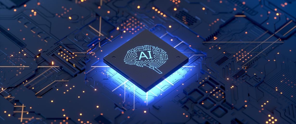 A computer data chip with the shape of brain on it and the term AI on a blue background that resembles the inner workings of a computer
