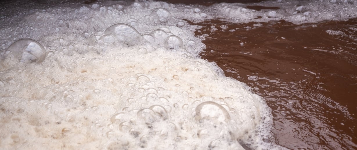 Bubbling brown waste water