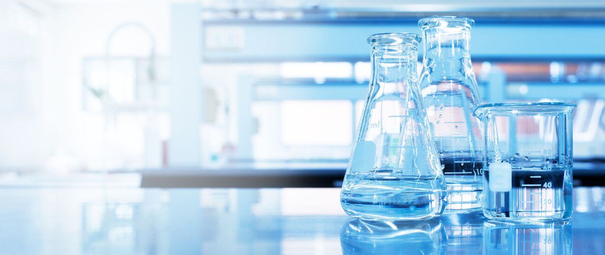 Glass laboratory jars filled with water on a lab tabletop