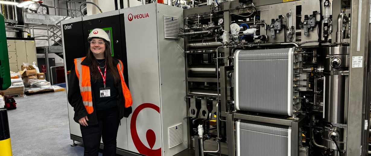 A female engineer standing in front of a process water treatment system